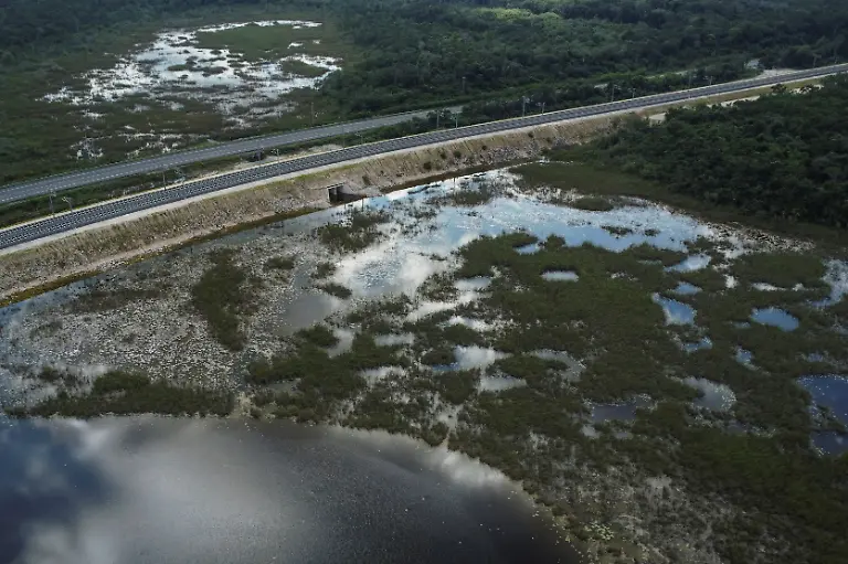 A-drone-view-shows-a-flooded-overpass-blocking-traffic-near-the-Maya-community-of-Uh-May-where-farmers-have-struggled-to-reach-their-fields-since-construction-of-the-Maya-Train-in-Felipe-Carrillo-Puerto-Quintana-Roo-state-Mexico-November-16-2025-Mexico-s-1-500-km-Mayan-Train-was-launched-to-drive-development-in-the-country-s-impoverished-south-through-infrastructure-and-tourism-but-two-years-after-its-inauguration-it-is-struggling-financially-ticket-sales-cover-only-a-fraction-of-costs-hotels-remain-largely-empty-and-communities-along-the-route-say-poverty-persists-and-promised-benefits-have-yet-to-materialize-A-Reuters-review-of-census-data-and-interviews-with-residents-along-the-line-found-that-poverty-remains-widespread-and-well-paid-jobs-scarce-despite-the-project-REUTERS-Daniel-Becerril-SEARCH-BECERRIL-MAYA-TRAIN-FOR-THIS-STORY-SEARCH-WIDER-IMAGE-FOR-ALL-STORIES