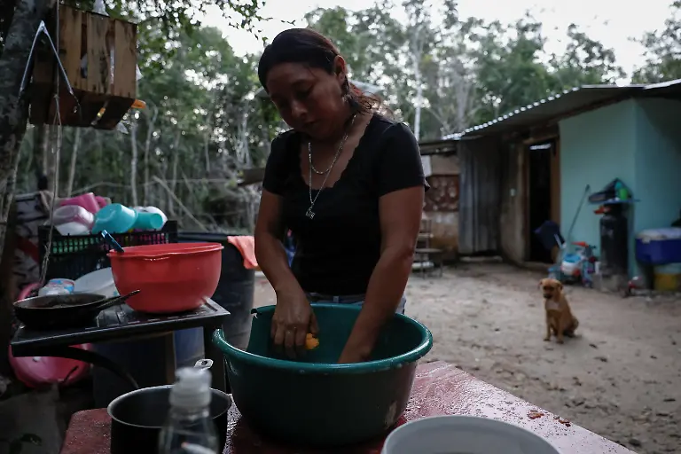 Mary-Sandra-Peraza-30-cooks-breakfast-for-her-family-at-their-home-where-they-lack-electricity-and-rely-on-solar-panels-and-a-generator-for-daily-tasks-near-a-Maya-Train-station-with-full-electrical-service-in-Vida-y-Esperanza-Quintana-Roo-state-Mexico-November-11-2025-Mexico-s-1-500-km-Mayan-Train-was-launched-to-drive-development-in-the-country-s-impoverished-south-through-infrastructure-and-tourism-but-two-years-after-its-inauguration-the-local-communities-near-the-line-say-they-have-seen-little-benefit-A-Reuters-review-of-census-data-and-interviews-with-dozens-of-residents-in-towns-along-the-track-found-that-poverty-remains-entrenched-and-well-paying-jobs-hard-to-find-It-s-not-like-we-re-asking-for-much-said-Peraza-There-s-no-real-benefit-for-us-REUTERS-Daniel-Becerril-SEARCH-BECERRIL-MAYA-TRAIN-FOR-THIS-STORY-SEARCH-WIDER-IMAGE-FOR-ALL-STORIES