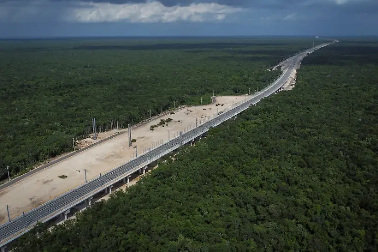 A-drone-view-shows-a-section-of-the-Maya-Train-built-over-the-Oppenheimer-cave-system-in-Playa-del-Carmen-Quintana-Roo-state-Mexico-November-15-2025-Mexico-s-1-500-km-Mayan-Train-was-launched-to-drive-development-in-the-country-s-impoverished-south-through-infrastructure-and-tourism-but-two-years-after-its-inauguration-it-is-struggling-financially-ticket-sales-cover-only-a-fraction-of-costs-hotels-remain-largely-empty-and-communities-along-the-route-say-poverty-persists-and-promised-benefits-have-yet-to-materialize-A-Reuters-review-of-census-data-and-interviews-with-residents-along-the-line-found-that-poverty-remains-widespread-and-well-paid-jobs-scarce-despite-the-project-REUTERS-Daniel-Becerril-SEARCH-BECERRIL-MAYA-TRAIN-FOR-THIS-STORY-SEARCH-WIDER-IMAGE-FOR-ALL-STORIES