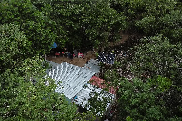 A-drone-view-shows-the-house-of-Mary-Sandra-Peraza-30-where-the-family-has-no-electricity-and-relies-on-solar-panels-and-a-generator-for-daily-tasks-near-a-Maya-Train-station-with-full-electrical-service-in-Vida-y-Esperanza-Quintana-Roo-state-Mexico-November-11-2025-Mexico-s-1-500-km-Mayan-Train-was-launched-to-drive-development-in-the-country-s-impoverished-south-through-infrastructure-and-tourism-but-two-years-after-its-inauguration-the-local-communities-near-the-line-say-they-have-seen-little-benefit-A-Reuters-review-of-census-data-and-interviews-with-dozens-of-residents-in-towns-along-the-track-found-that-poverty-remains-entrenched-and-well-paying-jobs-hard-to-find-It-s-not-like-we-re-asking-for-much-said-Peraza-There-s-no-real-benefit-for-us-REUTERS-Daniel-Becerril-SEARCH-BECERRIL-MAYA-TRAIN-FOR-THIS-STORY-SEARCH-WIDER-IMAGE-FOR-ALL-STORIES