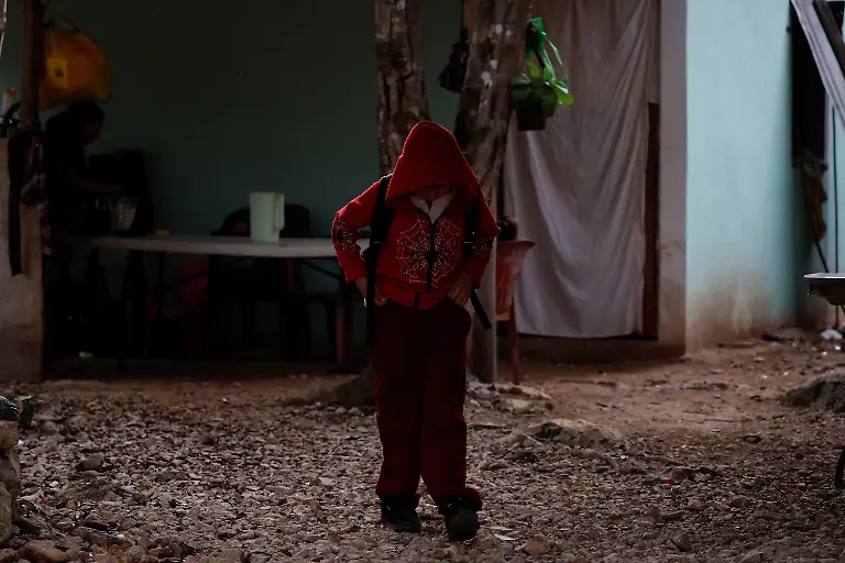 The-son-of-Mary-Sandra-Peraza-30-gets-ready-for-school-at-his-home-where-the-family-has-no-electricity-and-relies-on-solar-panels-and-a-generator-for-daily-tasks-near-a-Maya-Train-station-with-full-electrical-service-in-Vida-y-Esperanza-Quintana-Roo-state-Mexico-November-11-2025-Mexico-s-1-500-km-Mayan-Train-was-launched-to-drive-development-in-the-country-s-impoverished-south-through-infrastructure-and-tourism-but-two-years-after-its-inauguration-the-local-communities-near-the-line-say-they-have-seen-little-benefit-A-Reuters-review-of-census-data-and-interviews-with-dozens-of-residents-in-towns-along-the-track-found-that-poverty-remains-entrenched-and-well-paying-jobs-hard-to-find-It-s-not-like-we-re-asking-for-much-said-Peraza-There-s-no-real-benefit-for-us-REUTERS-Daniel-Becerril-SEARCH-BECERRIL-MAYA-TRAIN-FOR-THIS-STORY-SEARCH-WIDER-IMAGE-FOR-ALL-STORIES