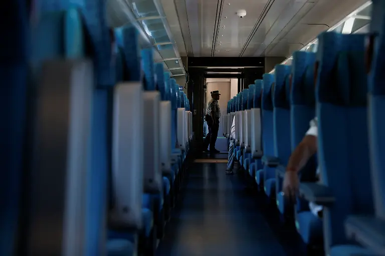 A-member-of-the-Mexican-National-Guard-stands-guard-on-board-a-Maya-Train-car-during-a-journey-from-Bacalar-to-Chetumal-in-Quintana-Roo-state-Mexico-November-12-2025-The-Mayan-Train-has-struggled-to-attract-the-expected-interest-after-legal-challenges-environmental-rerouting-and-land-constraints-pushed-key-segments-inland-leaving-many-stations-far-from-city-centers-and-airports-Reuters-visits-in-November-2025-found-mostly-empty-stations-and-lightly-occupied-trains-as-projected-annual-ridership-was-cut-to-1-2-million-and-the-project-s-cost-swelled-to-more-than-25-billion-with-revenues-covering-less-than-13-of-operating-costs-REUTERS-Daniel-Becerril-SEARCH-BECERRIL-MAYA-TRAIN-FOR-THIS-STORY-SEARCH-WIDER-IMAGE-FOR-ALL-STORIES