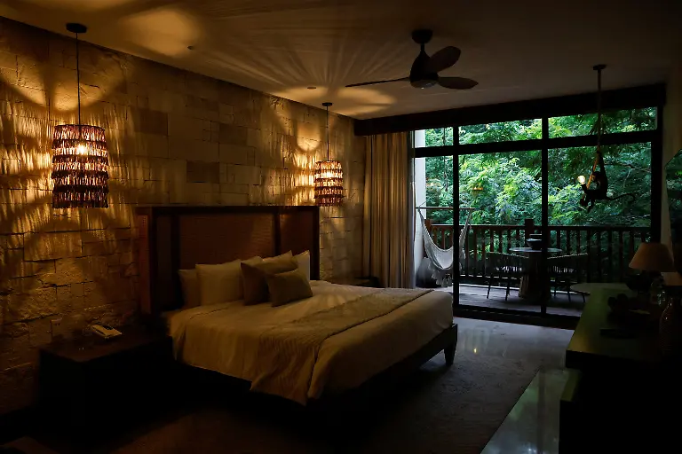 A-view-of-the-pool-area-at-the-Tren-Maya-Hotel-built-by-the-military-and-run-by-a-defense-ministry-agency-in-the-Calakmul-Biosphere-Reserve-in-Calakmul-Campeche-state-Mexico-November-13-2025-The-luxury-hotel-is-one-of-six-along-the-train-route-Government-data-reviewed-by-Reuters-shows-those-properties-averaged-monthly-occupancy-rates-between-5-and-24-most-of-last-year-Nicolas-Moreno-Jimenez-a-50-year-old-beekeeper-and-farmer-whose-family-was-displaced-decades-ago-when-the-government-created-the-Calakmul-reserve-a-UNESCO-World-Heritage-site-intended-to-protect-biodiversity-and-ruins-of-the-once-mighty-Mayan-empire-We-had-been-there-since-1980-said-Moreno-They-removed-us-in-1993-And-now-they-build-hotels-where-we-could-not-even-stay-REUTERS-Daniel-Becerril-SEARCH-BECERRIL-MAYA-TRAIN-FOR-THIS-STORY-SEARCH-WIDER-IMAGE-FOR-ALL-STORIES