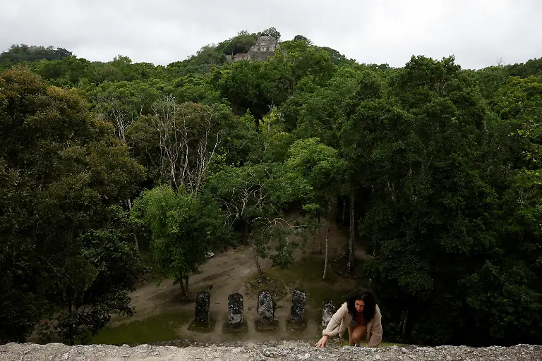 A-tourist-climbs-the-pyramids-at-the-Calakmul-archaeological-site-near-the-Tren-Maya-Hotel-built-by-the-military-and-run-by-a-defense-ministry-agency-in-Calakmul-Campeche-state-Mexico-November-13-2025-The-luxury-hotel-is-one-of-six-along-the-train-route-Government-data-reviewed-by-Reuters-shows-those-properties-averaged-monthly-occupancy-rates-between-5-and-24-most-of-last-year-Nicolas-Moreno-Jimenez-a-50-year-old-beekeeper-and-farmer-whose-family-was-displaced-decades-ago-when-the-government-created-the-Calakmul-reserve-a-UNESCO-World-Heritage-site-intended-to-protect-biodiversity-and-ruins-of-the-once-mighty-Mayan-empire-We-had-been-there-since-1980-said-Moreno-They-removed-us-in-1993-And-now-they-build-hotels-where-we-could-not-even-stay-REUTERS-Daniel-Becerril-SEARCH-BECERRIL-MAYA-TRAIN-FOR-THIS-STORY-SEARCH-WIDER-IMAGE-FOR-ALL-STORIES