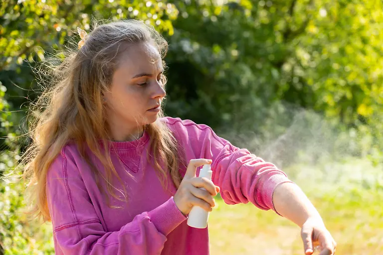Woman-spraying-insect-repellent-at-her-hand-outdoors-during-summer-Trying-to-kill-mosquitoes-and-flies-Clearly-visible-spray-droplets-Prevention-disinfection-against-mosquito-bite-Woman-spraying-insect-repellent-at-her-hand-outdoors-during-summer-Trying-to-kill-mosquitoes-and-flies-Clearly-visible-spray-droplets-Prevention-disinfection-against-mosquito-bite-during-sunny-day-model-released-96588770