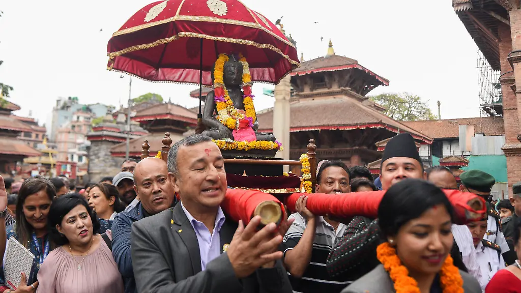 Devotees-and-officials-carry-the-historic-stone-Buddha-statue-known-as-Kwapa-Dyah-from-Hanuman-Dhoka-Museum-in-Kathmandu-Nepal-back-to-its-original-shrine-at-Nhuchhe-Baha-Bajradhatu-Vihar-in-Jor-Ganesh-Ombahal-on-May-1-2026-during-the-2570th-Buddha-Jayanti-The-Vajradhatu-Buddha-sculpture-significant-both-archaeologically-and-religiously-was-previously-stolen-and-later-found-at-the-Tibet-House-Collection-in-New-York-United-States-It-was-repatriated-to-Nepal-approximately-four-years-ago-and-kept-at-the-Chhauni-National-Museum-through-efforts-by-the-Department-of-Archaeology-heritage-activists-and-related-institutions-Following-legal-procedures-under-the-Ancient-Monument-Preservation-Act-2013-Section-20A-the-statue-is-now-formally-returned-to-its-original-guthi-custodians-marking-a-step-in-the-recovery-of-cultural-heritage-and-reinforcing-community-based-conservation-practices