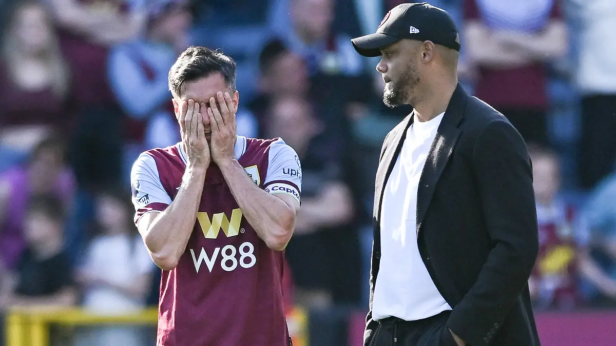 Jack-Cork-of-Burnley-and-Vincent-Kompany-Manager-of-Burnley-FC-react-after-their-sides-loss-and-Premier-League-relegation-after-the-Premier-League-football-match-between-Burnley-FC-and-Nottingham-Forest-at-Turf-Moor-in-Burnley-England