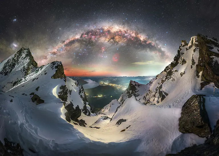 The-galactic-center-of-the-Milky-Way-composed-of-billions-of-stars-gas-and-dust-rises-above-an-icy-ancient-landscape-deep-within-Aoraki-Mount-Cook-National-Park-in-New-Zealand-part-of-the-largest-Gold-Tier-Dark-Sky-Reserve-in-the-world-This-was-one-of-the-most-remarkable-scenes-I-have-experienced-in-over-seven-years-of-astrophotography-The-stillness-clarity-and-calm-of-the-night-stood-in-stark-contrast-to-a-place-more-often-defined-by-its-wild-and-unpredictable-nature-There-is-a-unique-presence-here-where-the-night-sky-feels-seamlessly-connected-to-the-landscape-Beneath-the-towering-peaks-of-New-Zealand-s-highest-mountains-lies-the-Tasman-Glacier-the-largest-in-the-country-visible-in-the-foreground-The-glacier-along-with-the-lake-and-surrounding-valley-reflects-a-landscape-that-is-constantly-evolving-and-may-look-very-different-in-the-years-to-come-Above-it-the-Milky-Way-stretches-across-the-sky-vast-and-enduring-This-image-brings-together-different-timescales-in-a-single-moment-the-fleeting-nature-of-human-experience-the-gradual-transformation-of-the-land-and-the-ancient-continuous-flow-of-stars-overhead-It-serves-as-a-reminder-of-both-our-small-place-within-this-vast-system-and-the-privilege-of-witnessing-it