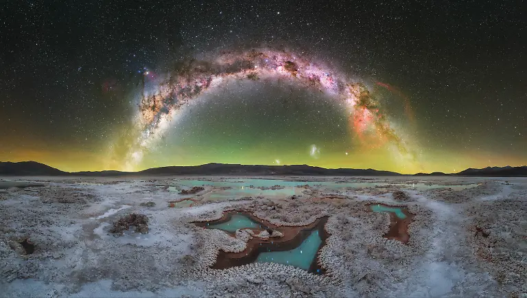 Reaching-this-location-required-traveling-deep-into-the-Argentine-Puna-a-remote-region-accessible-only-by-4-4-vehicles-along-rough-dirt-tracks-far-from-any-source-of-light-pollution-The-nearest-settlement-was-Antofalla-a-small-village-of-around-60-inhabitants-where-electricity-is-generated-locally-and-turned-off-at-night-Beyond-that-the-closest-towns-are-several-hours-away-surrounded-by-vast-and-isolated-landscapes-Situated-between-3-500-and-4-000-meters-above-sea-level-the-altitude-and-remoteness-make-this-an-exceptional-environment-for-night-sky-photography-What-made-this-place-particularly-compelling-was-its-rarity-I-had-never-seen-photographs-of-this-salt-flat-before-and-its-untouched-character-and-minimalist-landscape-immediately-stood-out-Photographing-the-Milky-Way-in-the-southern-hemisphere-brought-both-challenges-and-excitement-as-its-appearance-differs-significantly-from-what-I-was-used-to-in-the-north-In-this-moment-the-galactic-center-sits-to-the-left-side-of-the-arch-while-the-Gum-Nebula-appears-on-the-right-creating-a-natural-visual-balance-across-the-sky