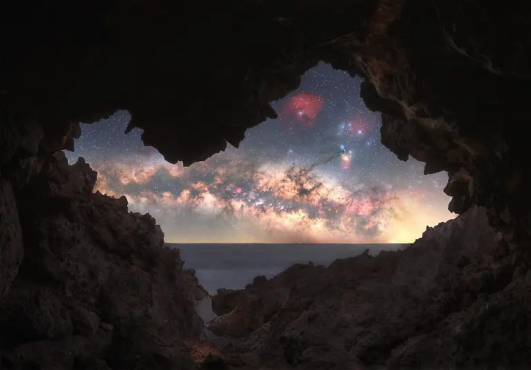 I-m-always-drawn-to-locations-that-feel-unique-and-relatively-undiscovered-and-this-cave-was-a-perfect-example-Although-it-was-only-a-few-minutes-from-the-parking-area-it-took-me-nearly-four-hours-of-scouting-to-finally-locate-it-The-conditions-made-the-process-even-more-demanding-Intense-heat-combined-with-powerful-winds-made-movement-difficult-at-times-pushing-me-against-sharp-rocks-After-nearly-giving-up-and-heading-back-I-finally-came-across-the-cave-a-moment-that-made-the-entire-search-worthwhile-Capturing-the-image-proved-just-as-challenging-Composing-and-shooting-the-panoramic-foreground-required-careful-positioning-while-properly-illuminating-the-upper-section-of-the-cave-was-particularly-difficult-To-manage-this-I-used-focus-stacking-across-different-planes-including-the-upper-edge-the-horizon-and-the-lower-foreground-all-in-near-total-darkness-where-the-brief-blue-hour-offered-little-assistance-With-the-Milky-Way-sitting-low-on-the-horizon-bringing-out-its-color-and-detail-required-additional-effort-in-both-capture-and-processing-In-the-end-the-result-reflects-not-only-the-scene-itself-but-also-the-persistence-and-experience-behind-it-making-it-especially-meaningful
