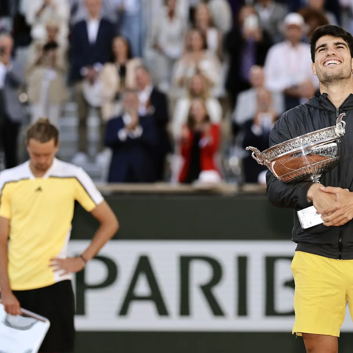 Carlos-Alcaraz-of-Spain-holds-the-victor-s-trophy-after-winning-the-men-s-singles-final-against-Germany-s-Alexander-Zverev-L-at-the-French-Open-tennis-tournament-in-Paris-on-June-9-2024