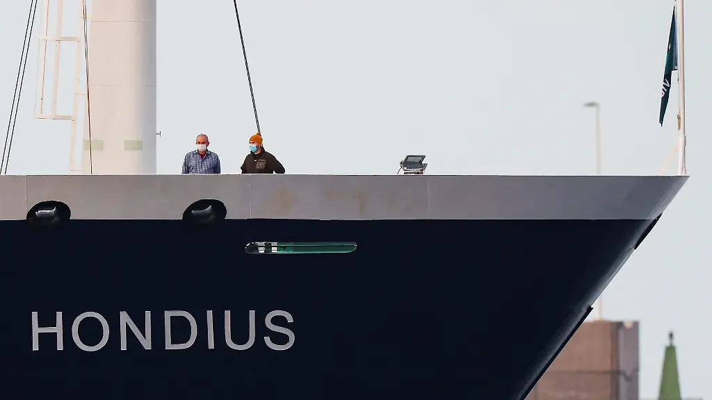 People-wearing-masks-stand-aboard-the-cruise-ship-MV-Hondius-at-the-port-of-Granadilla-de-Abona-after-being-affected-by-a-hantavirus-outbreak-in-Tenerife-Spain-May-10-2026