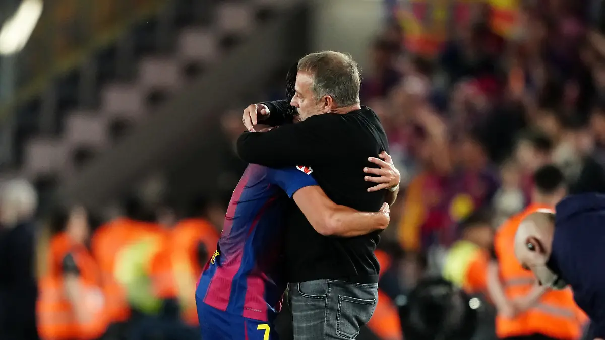 Barcelona-s-Ferran-Torres-hugs-Barcelona-head-coach-Hansi-Flick-after-scoring-his-side-s-second-goal-during-the-Spanish-La-Liga-soccer-match-between-FC-Barcelona-and-Real-Madrid-in-Barcelona-Spain-Sunday-May-10-2026