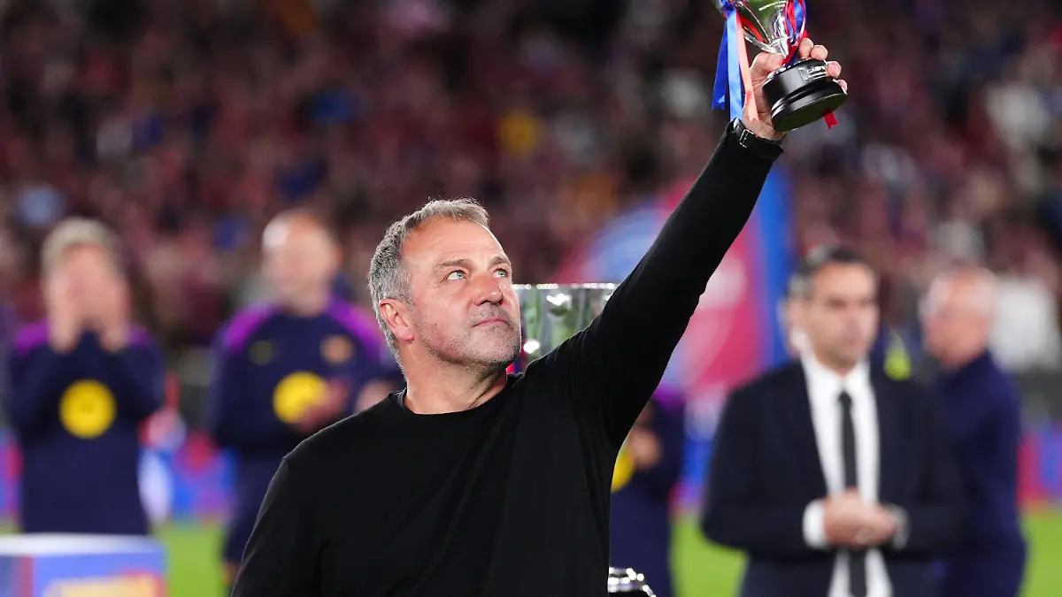 Barcelona-head-coach-Hansi-Flick-lifts-his-award-to-the-sky-celebrating-after-defeating-Real-Madrid-2-0-to-win-the-Spanish-La-Liga-soccer-championship-with-three-rounds-to-spare-in-Barcelona-Spain-Sunday-May-10-2026