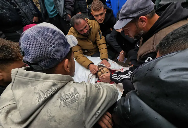 Palestinians-bid-farewell-to-the-bodies-of-two-men-inside-the-morgue-at-Nasser-Medical-Complex-after-they-were-killed-in-an-Israeli-airstrike-that-targeted-a-police-station-last-night-in-Khan-Younis-southern-Gaza-Strip-April-1-2026