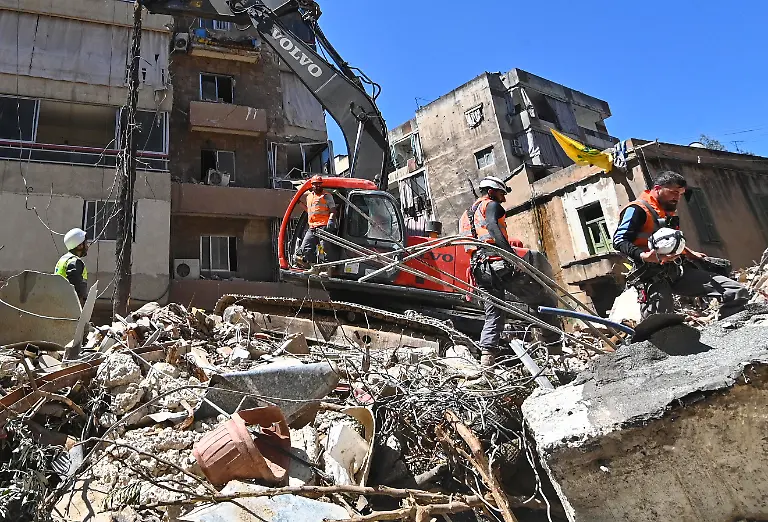 First-responders-inspect-the-rubble-of-a-collapsed-building-in-Beirut-s-southern-suburb-of-Haret-Hreik-Lebanon-on-May-7-2026-Israel-conducted-military-operations-in-Beirut-s-southern-suburbs-on-May-6-marking-the-first-such-event-in-nearly-a-month-A-senior-Hezbollah-commander-from-its-elite-Radwan-force-was-among-those-killed-At-least-11-others-were-reported-dead-in-operations-across-the-country-s-south-and-east-according-to-Lebanon-s-health-ministry