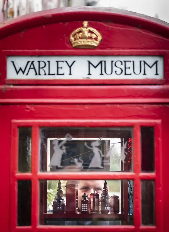 Warley-Museum-Halifax-Peter-Kemp-looks-through-the-window-of-one-of-the-UK-s-most-unusual-museums-the-Warley-Museum-in-Halifax-West-Yorkshire-that-is-situated-inside-a-disused-British-Telecom-phone-booth-Picture-date-Monday-January-10-2022-The-museum-sits-quietly-in-the-village-of-Warley-in-the-Calder-Valley-and-exhibits-of-local-history-artefacts