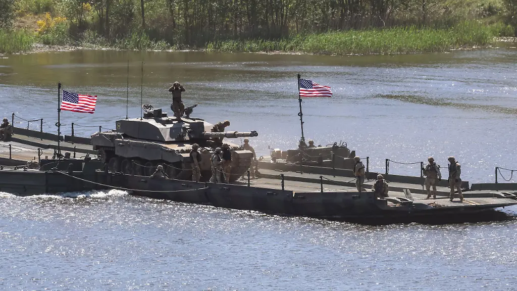 May-17-2024-Drawsko-Pomorskie-West-Pomeranian-Poland-American-soldiers-of-the-US-29th-Infantry-Division-of-the-National-Guard-cross-Zly-Leg-lake-seen-during-an-exercise-in-Land-Forces-Training-Centre-in-Drawsko-as-part-of-wide-raging-exercise-of-NATO-allies-Steadfast-Defender-2024-The-exercise-is-aimed-to-check-military-abilities-of-the-North-Atlantic-alliance-in-a-possibility-of-Russian-aggression-on-Poland-and-Baltic-States-which-are-on-the-NATO-East-Flank