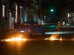 Menschen Fahren Mit Einem Amerikanischen Oldtimer Durch Eine Barrikade Die Von Anwohnern Errichtet Wurde Die Gegen Anhaltende Stromausfaelle In Havanna Protestieren