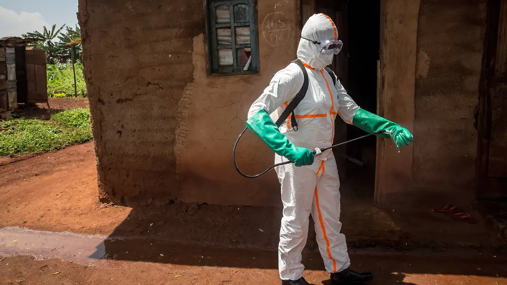 June-13-2019-Beni-Democratic-Republic-of-Congo-World-Health-Organization-worker-Belinda-Landu-28-decontaminates-the-house-of-a-pastor-who-has-just-tested-positive-for-Ebola-in-Beni-The-DRC-is-currently-experiencing-the-second-largest-Ebola-outbreak-in-recorded-history-and-the-response-is-hampered-by-it-being-in-an-active-conflict-zone-More-than-1-400-people-have-died-since-August-2018