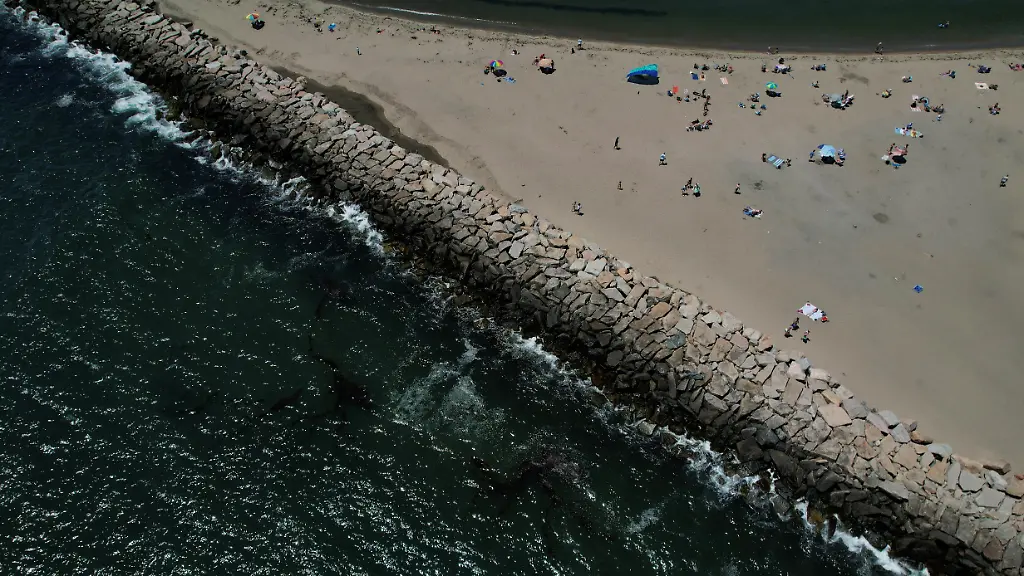 Beachgoers-use-a-sandy-area-on-a-summer-day-at-Camp-Cronin-Fishing-Area-in-Narragansett-Rhode-Island-U-S-July-7-2022