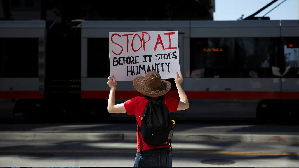 A-protester-holds-a-sign-during-a-protest-outside-of-OpenAI-headquarters-calling-for-a-pause-in-AI-development-in-San-Francisco-California-U-S-March-21-2026