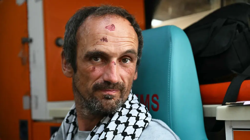 A-member-of-the-Global-Sumud-Flotilla-headed-for-Gaza-and-arrested-and-deported-by-Israel-poses-as-he-receives-medical-attention-following-the-group-s-arrival-at-Istanbul-Airport-on-May-21-2026-The-first-of-hundreds-of-Gaza-flotilla-activists-began-arriving-at-Istanbul-airport-on-may-21-after-being-arrested-then-deported-from-Israel-an-AFP-correspondent-said-The-422-activists-who-were-flown-from-southern-Israel-on-three-planes-chartered-by-Ankara-had-been-part-of-a-fleet-of-around-50-vessels-that-set-sail-from-southern-Turkey-on-May-14-seeking-to-break-Israel-s-blockade-on-Gaza-which-was-joined-at-sea-by-several-others