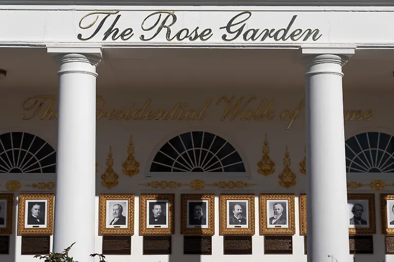 A-sign-for-the-Rose-Garden-is-seen-near-the-Presidential-Walk-of-Fame-on-the-Colonnade-at-the-White-House-Tuesday-Jan-13-2026-in-Washington