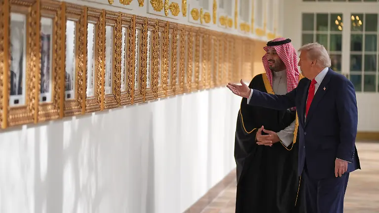 President-Donald-Trump-and-Saudi-Arabia-s-Crown-Prince-Mohammed-bin-Salman-walk-along-the-Colonnade-at-the-White-House-Tuesday-Nov-18-2025-in-Washington