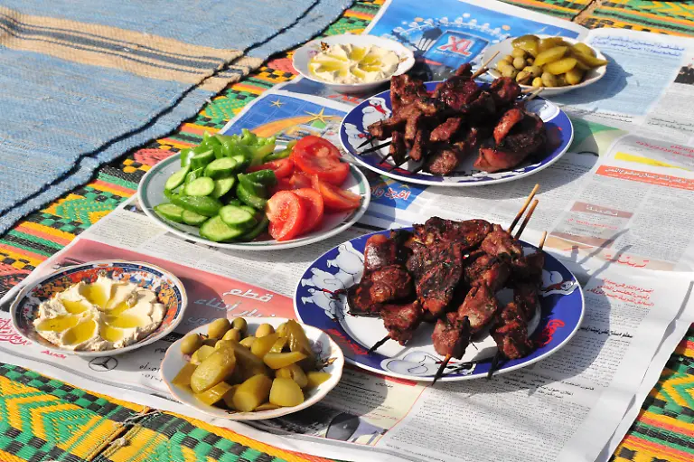 LAKIYA-ISR-DEC-12-Cooked-lamb-meat-and-salads-on-Eid-al-Adha-Dec-8-2008-The-festival-is-celebrated-by-sacrificing-a-lamb-or-other-animal-and-distributing-the-meat-to-relatives-friends-and-the-poor
