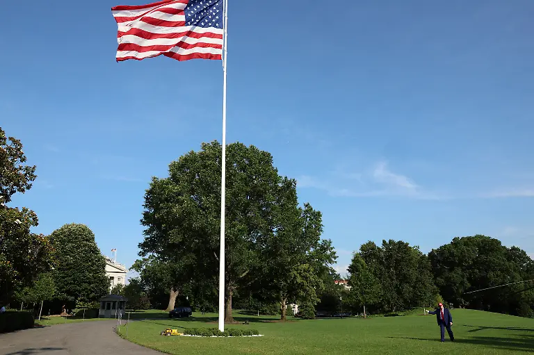 U-S-President-Donald-Trump-gestures-next-to-a-new-flagpole-with-the-U-S-flag-after-disembarking-Marine-One-upon-arrival-at-the-White-House-in-Washington-D-C-U-S-June-21-2025