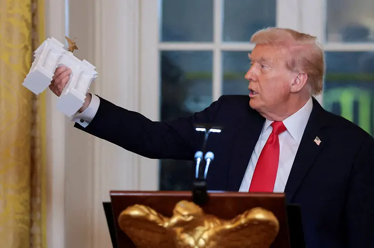 U-S-President-Donald-Trump-holds-a-model-of-an-arch-monument-during-a-ballroom-dinner-in-the-East-Room-at-the-White-House-in-Washington-D-C-U-S-October-15-2025