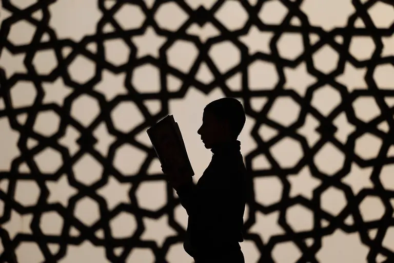 April-2-2022-Gaza-city-Gaza-Strip-Palestinian-Territory-A-Palestinian-boy-reads-the-Koran-at-the-Khalidi-Mosque-on-the-first-Day-of-the-Muslim-fasting-month-of-Ramadan-in-Gaza-City-on-April-2-2022-Credit-Image-Osama-Baba-APA-Images-via-ZUMA-Press-Wire