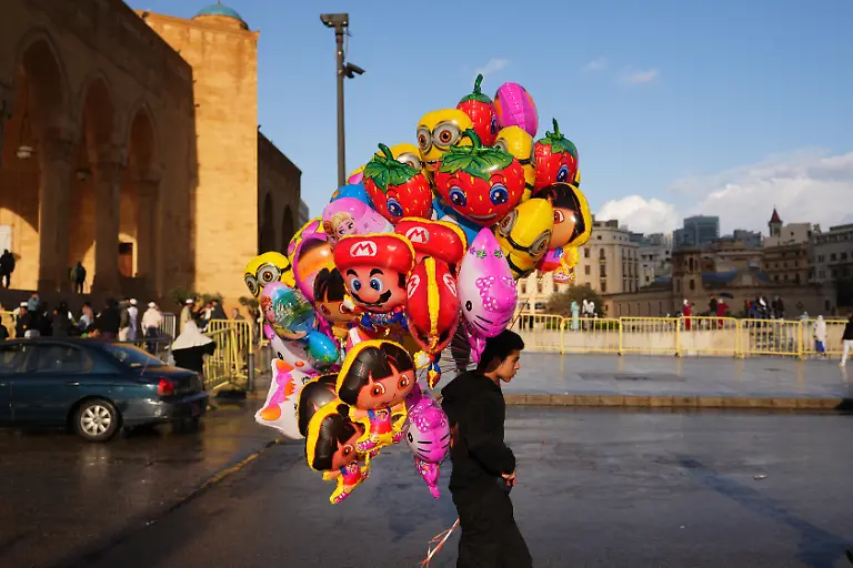 A-boy-carries-balloons-for-sale-outside-the-Mohammad-Al-Amin-Mosque-during-Eid-al-Fitr-celebrations-in-Beirut-Lebanon-Friday-March-20-2026