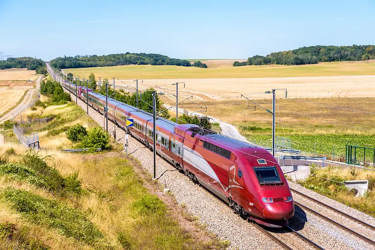 A-Thalys-high-speed-train-in-the-countryside-Baron-France-July-29-2020-A-Thalys-PBKA-high-speed-train-is-driving-from-Paris-to-Brussels-on-the-LGV-Nord-the-North-European-high-speed-railway-line-in-the-french-countryside