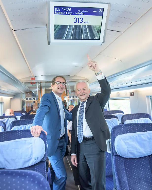PARIS-FRANCE-JULY-23-Transport-and-Digital-Technologie-Mininister-Alexaner-Dobrindt-CSU-L-and-Deutsche-Bahn-CEO-Ruediger-Grube-R-look-to-a-monitor-in-the-new-ICE-3-that-shows-the-train-speed-of-313-KM-h-on-July-23-2015-near-Paris-France-The-new-ICE-3-in-the-Franco-German-high-speed-rail-has-been-officially-launched-with-a-trip-from-Frankfurt-to-Paris