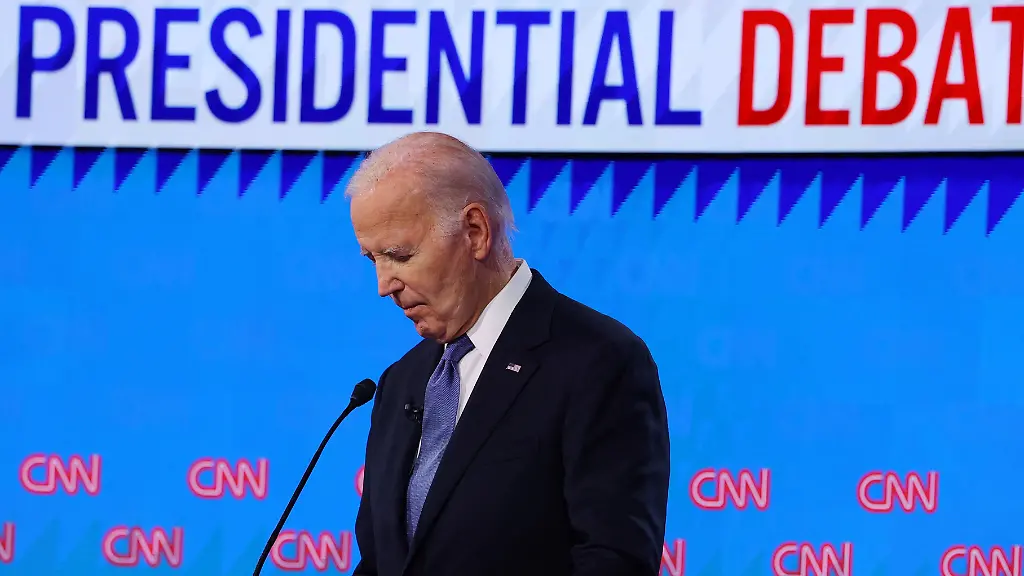 Democrat-presidential-candidate-U-S-President-Joe-Biden-listens-as-Republican-presidential-candidate-and-former-U-S-President-Donald-Trump-speaks-during-their-debate-in-Atlanta-Georgia-U-S-June-27-2024