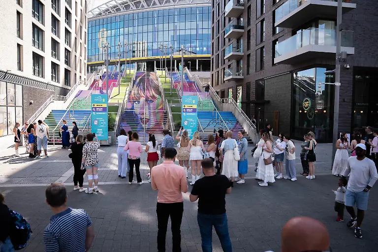 Taylor-Swift-s-Eras-Tour-London-Swifties-line-up-to-pose-in-front-of-a-mural-outside-Wembley-as-they-gather-outside-the-Stadium-in-north-west-London-ahead-of-second-night-in-the-latest-run-of-Taylor-Swift-Eras-Tour-concerts-at-the-venue-Picture-date-Friday-August-16-2024-See-PA-story-SHOWBIZ-Swift