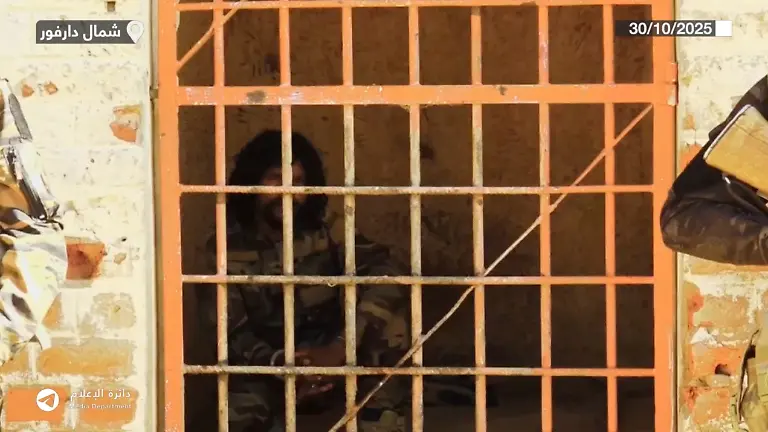 RSF-commander-al-Fateh-Abdullah-Idris-known-as-Abu-Lulu-looks-on-after-he-is-brought-into-Shala-prison-in-southwestern-al-Fashir-Sudan-in-this-screengrab-from-a-handout-video-released-October-30-2025-RSF-Handout-via-REUTERS-THIS-IMAGE-HAS-BEEN-SUPPLIED-BY-A-THIRD-PARTY-NO-RESALES-NO-ARCHIVES-MANDATORY-CREDIT-OVERLAYS-FROM-SOURCE-VERIFICATION-Reuters-was-unable-to-verify-the-precise-location-where-the-video-was-filmed-Reuters-was-able-to-identify-one-of-the-people-in-the-video-as-Salah-Obari-an-RSF-commander-who-was-also-identified-in-videos-from-al-Fashir-in-October-2025-No-older-version-of-the-video-found-before-November-1-The-armed-men-in-the-video-are-confirmed-to-be-RSF-by-the-uniforms-and-patches-they-wear