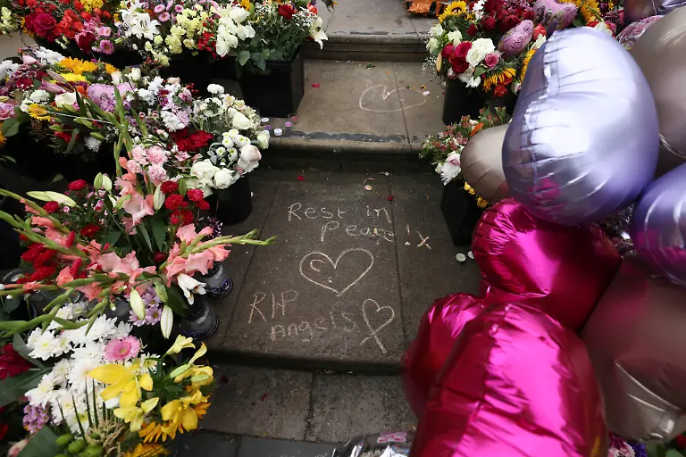 FILE-Tributes-are-seen-outside-the-Town-Hall-in-Southport-England-Monday-Aug-5-2024-after-three-young-girls-were-killed-in-a-knife-attack-at-a-Taylor-Swift-themed-holiday-club-the-week-before