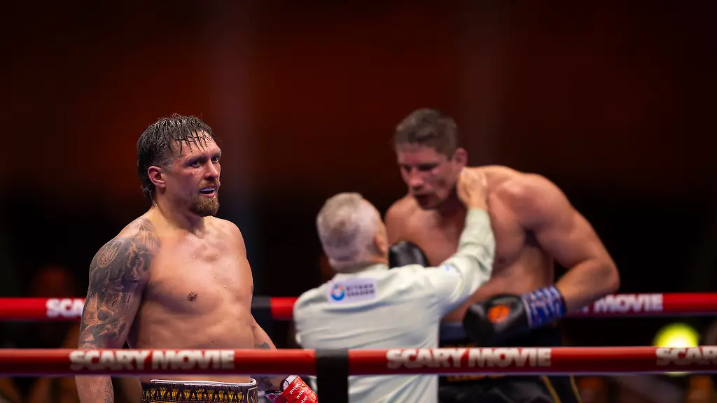 Giza-Egypt-Usyk-Verhoeven-Heavyweight-Boxing-Oleksandr-Usyk-L-stands-in-the-boxing-ring-as-the-referee-center-speaks-to-Rico-Verhoeven-R-as-their-match-comes-to-an-end-in-Giza-Egypt-on-May-24-2026-Oleksandr-Usyk-retained-his-WBC-heavyweight-titles-after-defeating-Rico-Verhoeven-by-an-11th-round-stoppage-during-the-Glory-in-Giza-boxing-event-at-the-Pyramids-of-Giza