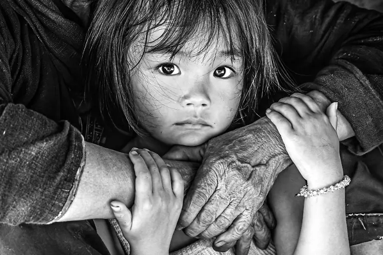 In-her-grandmother-s-worn-hands-a-little-girl-finds-the-warmth-of-generations-a-quiet-strength-born-of-love-and-survival
