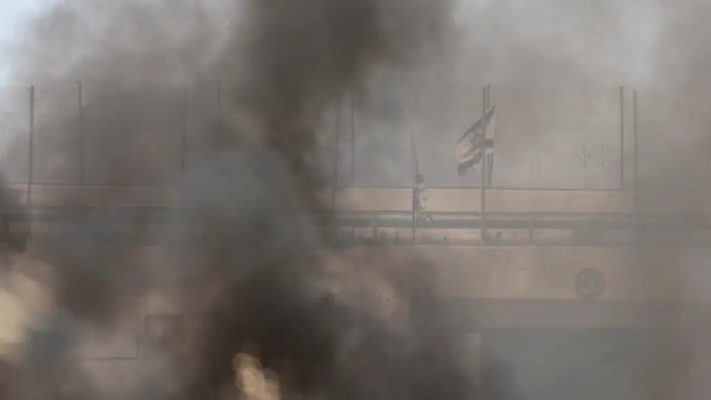 An-Israeli-flag-is-seen-through-smoke-from-fire-in-a-field-which-local-Palestinians-say-has-been-set-by-Israeli-settlers-in-the-town-of-Huwwara-near-Nablus-in-the-Israeli-occupied-West-Bank-June-6-2026