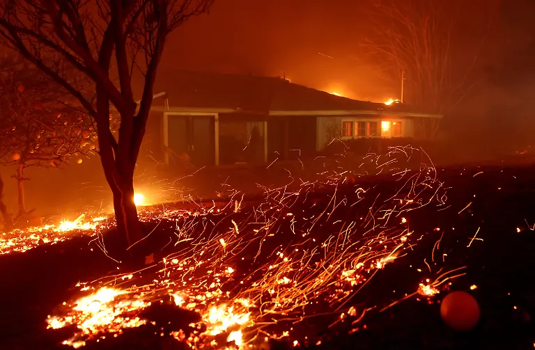 ALTADENA-CALIFORNIA-JANUARY-08-Wind-pushes-embers-into-a-home-as-the-Eaton-Fire-moves-through-the-area-on-January-08-2025-in-Altadena-California-Fueled-by-intense-Santa-Ana-Winds-the-Palisades-Fire-has-grown-to-over-2-900-acres-and-30-000-people-have-been-ordered-to-evacuate-while-a-second-fire-has-emerged-near-Eaton-Canyon-in-Altadena