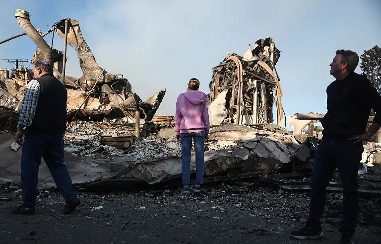 PACIFIC-PALISADES-CALIFORNIA-JANUARY-10-Rev-John-Shaver-R-looks-on-while-visiting-the-remains-of-Community-United-Methodist-Church-where-he-is-pastor-as-wildfires-cause-damage-and-loss-through-Los-Angeles-County-on-January-10-2025-in-Pacific-Palisades-California-Rev-Shaver-plans-to-rebuild-the-church-and-also-lost-his-home-in-the-fire-Multiple-wildfires-fueled-by-intense-Santa-Ana-Winds-are-burning-across-Los-Angeles-County-Reportedly-at-least-10-people-have-died-with-over-180-000-people-having-been-under-evacuation-orders-Over-9-000-structures-have-been-damaged-or-burned-while-more-than-more-than-25-000-acres-were-burning-from-the-fires