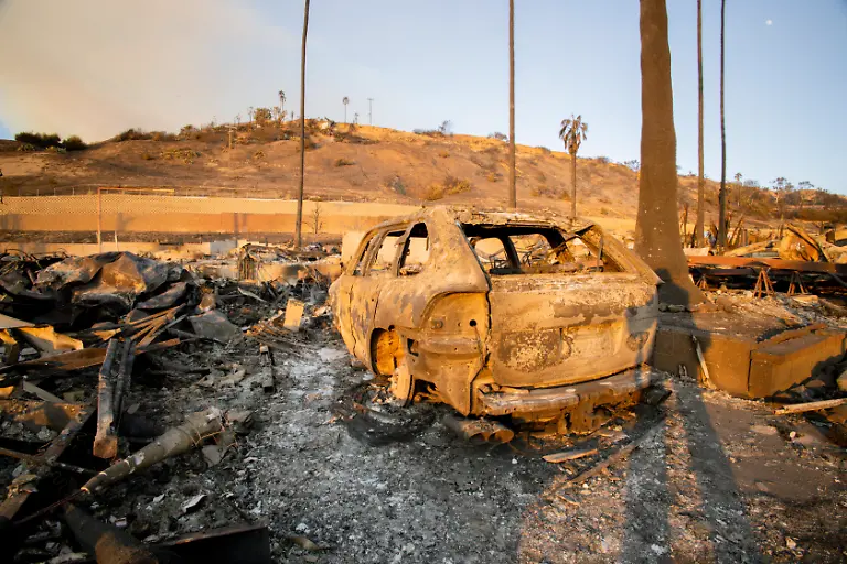 Aftermath-Of-Los-Angeles-Wildfires-January-10-A-burned-vehicle-remains-on-the-side-of-the-road-in-Southern-California-on-January-10-2025-The-California-wildfires-have-collectively-scorched-nearly-38-000-acres-with-Governor-Gavin-Newsom-describing-them-as-among-the-most-severe-in-U-S-history-and-damages-projected-to-exceed-135-billion