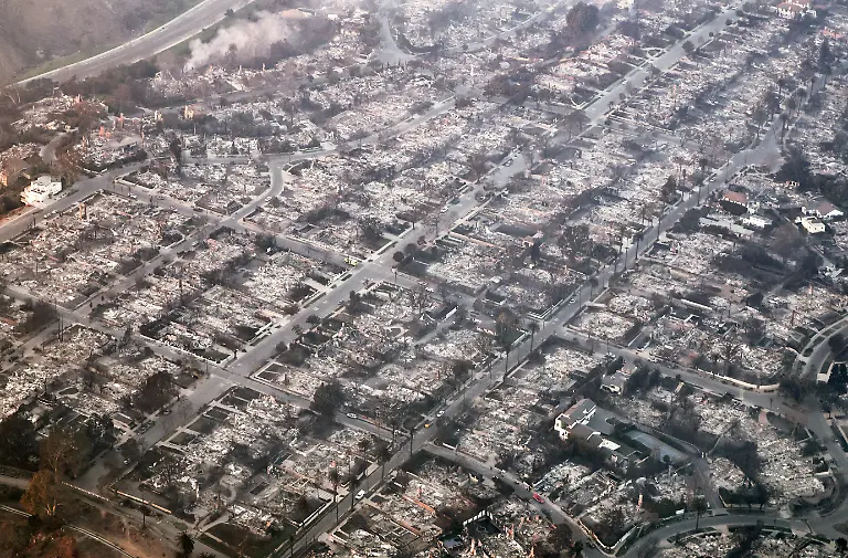 PACIFIC-PALISADES-CALIFORNIA-JANUARY-09-In-an-aerial-view-destroyed-homes-are-seen-as-the-Palisades-Fire-continues-to-burn-on-January-09-2025-in-Pacific-Palisades-California-Multiple-wildfires-fueled-by-intense-Santa-Ana-Winds-are-burning-across-Los-Angeles-County-At-least-five-people-have-been-killed-and-over-25-000-acres-have-burned-Over-2-000-structures-have-also-burned-and-almost-180-000-people-are-under-orders-to-evacuate