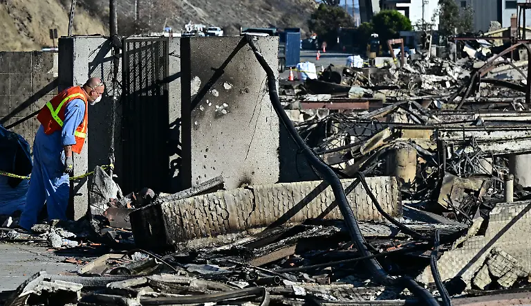 Southern-California-Gas-Company-workers-check-the-area-to-make-sure-gas-lines-are-off-at-burned-out-homes-reduced-to-rubble-by-the-Palisades-Fire-along-Pacific-Coast-Highway-in-Malibu-California-on-January-17-2025-Tens-of-thousands-of-people-ordered-to-flee-their-homes-as-wildfires-tore-through-Los-Angeles-were-told-on-January-16-they-would-not-be-allowed-back-for-at-least-a-week-with-fears-over-electrocution-landslides-and-exposure-to-toxic-materials-Frustration-is-mounting-among-evacuees-who-are-angry-over-rules-that-restrict-them-from-returning-to-their-homes-even-if-the-structures-survived-the-deadly-blazes-Photo-by-Frederic-J
