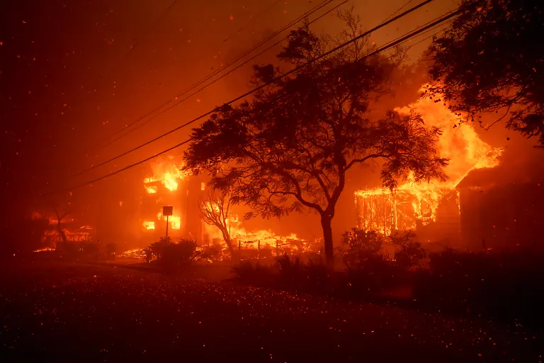 LOS-ANGELES-CALIFORNIA-JANUARY-7-Flames-from-the-Palisades-Fire-burn-homes-on-January-7-2025-in-the-Pacific-Palisades-neighborhood-of-Los-Angeles-California-Fueled-by-intense-Santa-Ana-Winds-the-Palisades-Fire-has-grown-to-over-2-900-acres-and-30-000-people-have-been-ordered-to-evacuate-while-a-second-fire-has-emerged-near-Eaton-Canyon