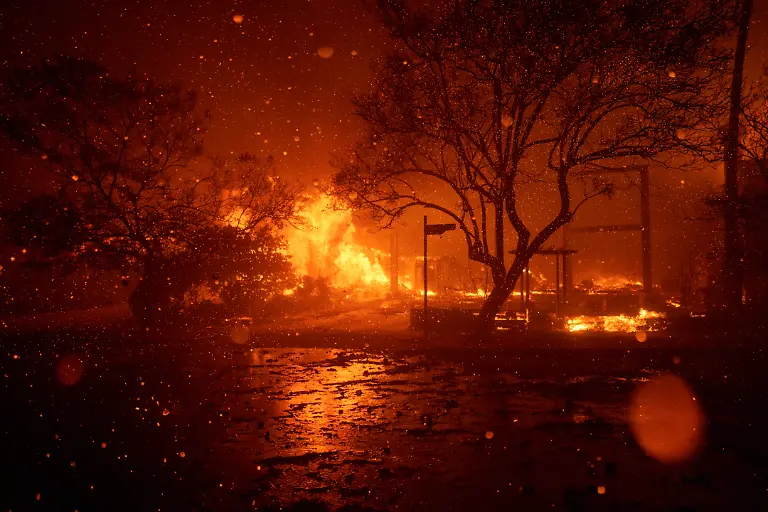 LOS-ANGELES-CALIFORNIA-JANUARY-7-Flames-from-the-Palisades-Fire-burn-a-home-on-January-7-2025-in-the-Pacific-Palisades-neighborhood-of-Los-Angeles-California-Fueled-by-intense-Santa-Ana-Winds-the-Palisades-Fire-has-grown-to-over-2-900-acres-and-30-000-people-have-been-ordered-to-evacuate-while-a-second-fire-has-emerged-near-Eaton-Canyon